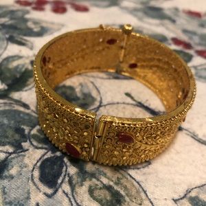 Gold color bangle with multicolored stone